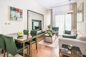 Relax in a stylish space with a dining area, seating area, and wall-mounted TV.