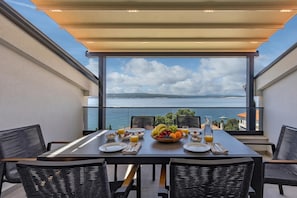 A dining table with breakfast items, wicker chairs, and a view of the sea. - Pool Apartments Crikvenica (Crikvenica)