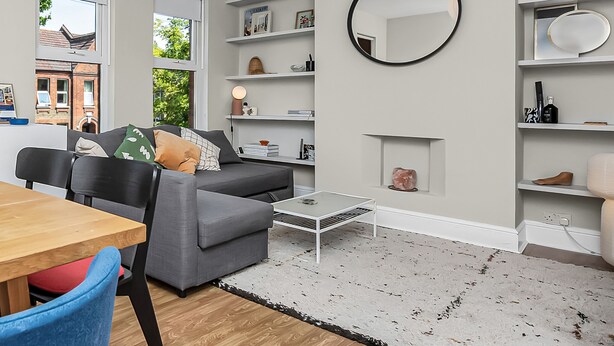 A modern living room with a dining area, a fireplace, and built-in shelving. - Unique 2 bedroom Flat in Heart of Walthamstow (Greater London)