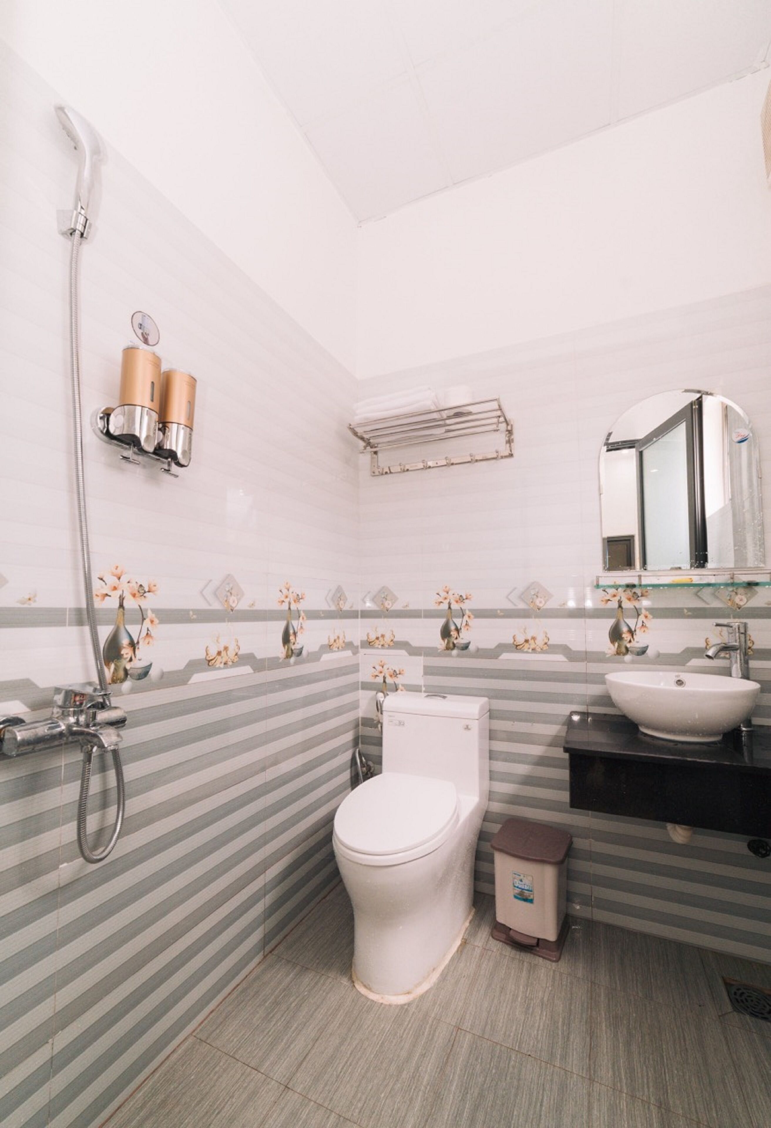 A bathroom with a toilet, sink, and shower.