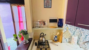 A compact kitchen with a gas stove, a sink, and a small countertop. - Vacation home (Monforte d'Alba)