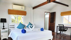 A bedroom with a bed, bedside table, lamp, and a desk with a chair. - Sand Terrace Beach Bungalows (Ko Pha-ngan)