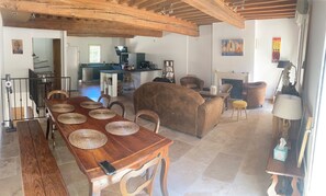 Cozy living area with a fireplace, dining table, and comfortable seating.