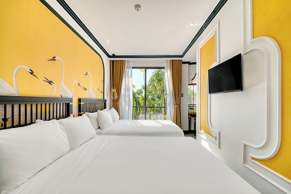 A hotel room with two beds, a TV, and a mural of swans on the wall. - Rokas Hoi An Boutique Hotel (Da Nang)