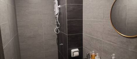 A modern bathroom with a toilet, sink, and shower.
