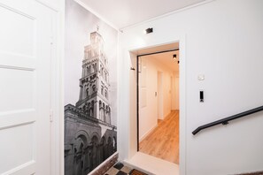Stylish hallway with a large photograph and a staircase leading to the upper floors.