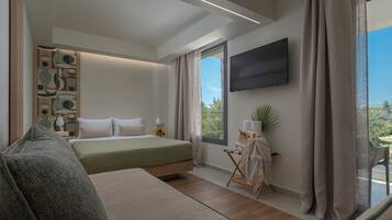 A modern bedroom with a bed, a seating area, a flat-screen TV, and a balcony with curtains.