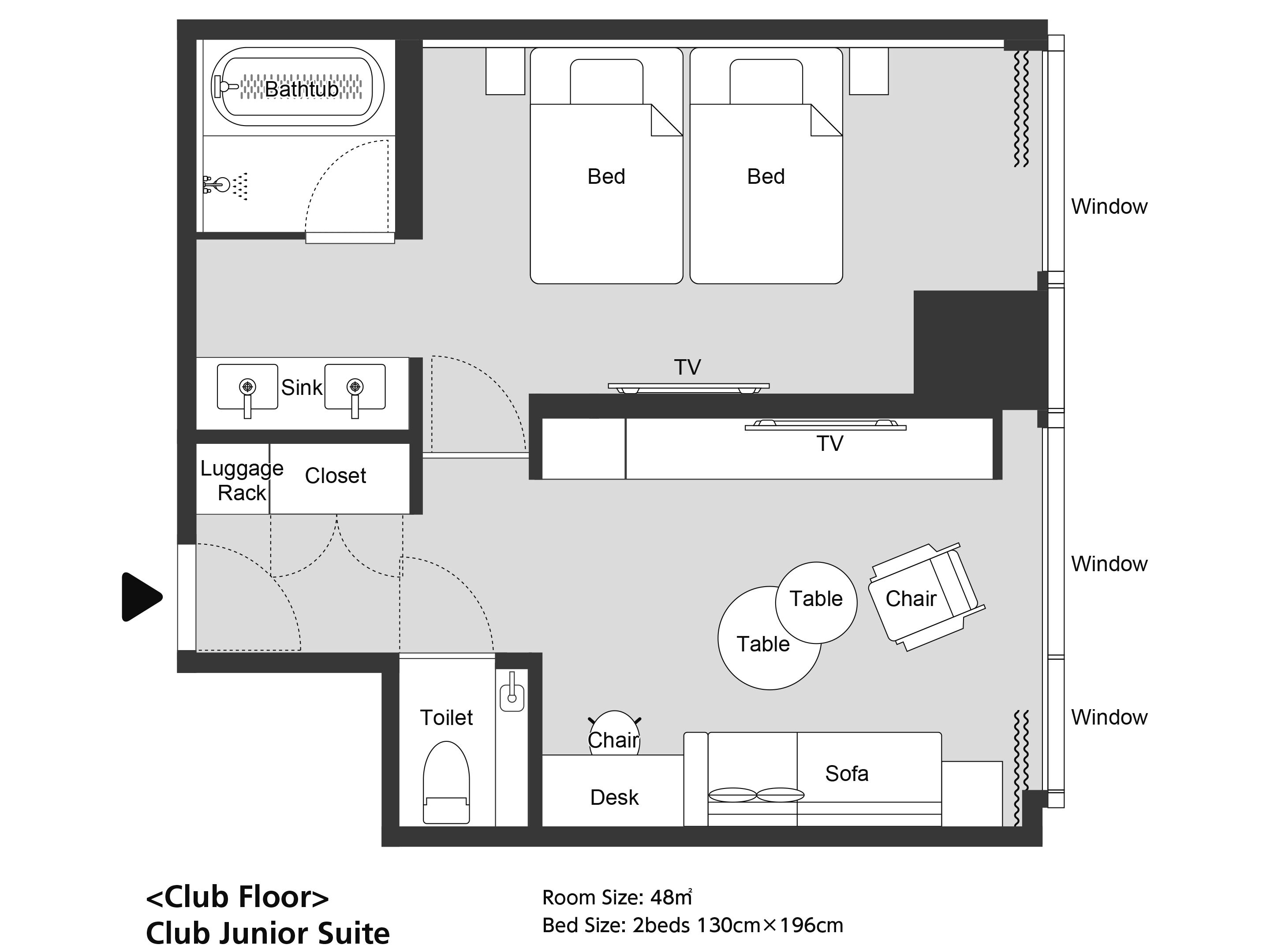 Distribución de una Suite Junior Club con dos camas, televisión, baño, escritorio, sofá y mesa.
