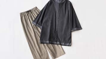 A pair of pants and a shirt laid out on a flat surface.