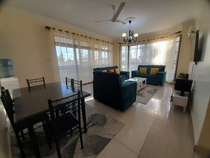 Family Apartment | Living area | 24-inch Smart TV with digital channels - Lux Suites PK Ocean View Apartments (Mombasa)
