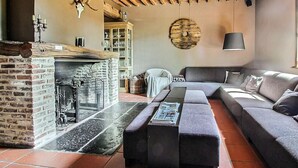 A cozy living room with a fireplace, a sofa, and a coffee table. - Amazing home in Gedinne with sauna (Gedinne)