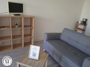 Relax in this stylish living room with a sofa, coffee table, and flat-screen TV.