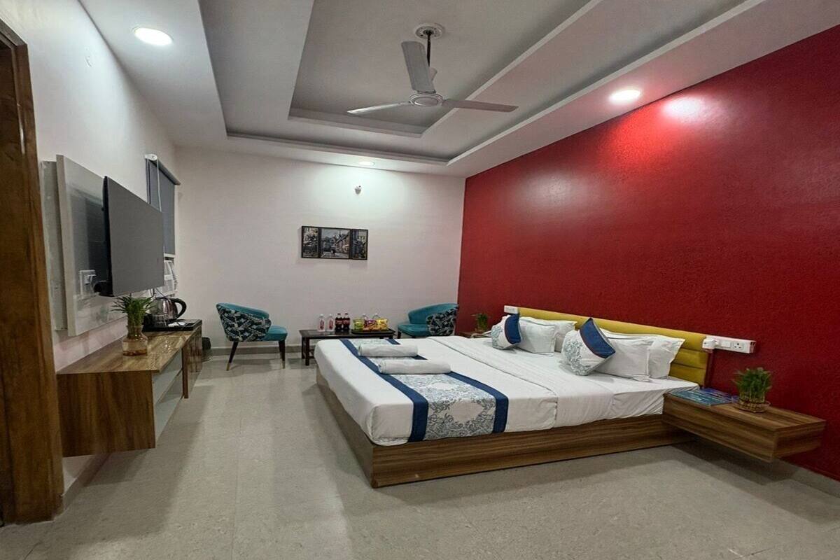A modern bedroom with a bed, a desk, and a chair.
