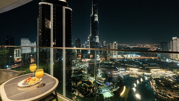 A high-rise balcony with a cityscape view, including a prominent tower. - New 4BR Penthouse | Burj Khalifa View |Opera Grand (Dubai)