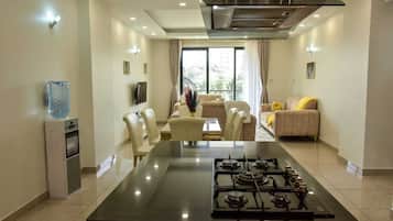 Executive Apartment, Balcony, City View | Living area | 32-inch Smart TV with digital channels