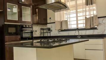 Executive Apartment, Balcony, City View | Private kitchen | Fridge, microwave, cookware/dishes/utensils