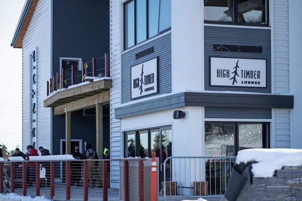 A modern building with a sign for "High Timber Lounge" on the facade.