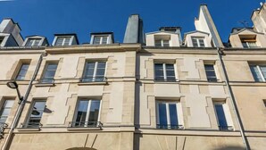 Un edificio a più piani con uno stile architettonico classico, caratterizzato da finestre e balconi simmetrici.