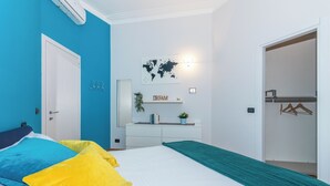 A bedroom with a bed, a dresser, a world map, and a 'DREAM' sign. - Casa Boccaccio by Wonderful Italy (Turin)