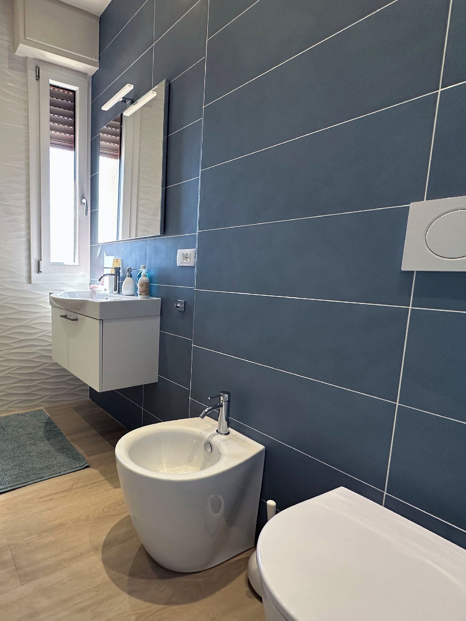 Une salle de bain moderne avec une baignoire sur pieds, des toilettes et un meuble-lavabo avec un miroir.
