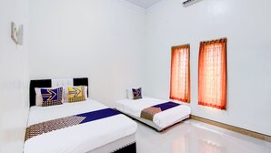 A hotel room with two beds, a white wall, and an air conditioning unit. - Hotel O Homestay Putra Syariah (Kasihan)