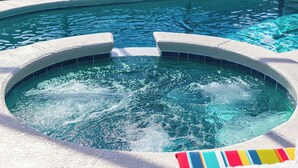 A hot tub with a circular design, surrounded by a concrete edge. - ⭐NEWLY REFURBISHED | 4 Bed Villa | Large Private Pool Deck | Minutes to Disney⭐ (Davenport)