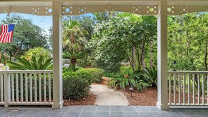 A covered outdoor area with a pathway, white railings, and an American flag.