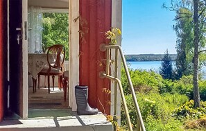 Relax in a serene outdoor space with a clear view of the water and lush greenery, featuring a comfortable seating area and a secure pathway.