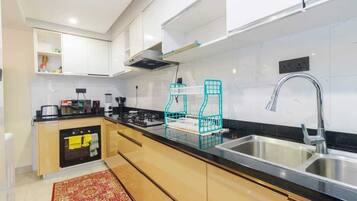Apartemen Deluks | Dapur pribadi | Lemari es, microwave, peralatan masak/sendok-piring, dan meja makan