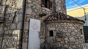 A stone building with a sign for 'Old House Nivice' and 'The First Wine Fountain in the World'. - Old house Njivice (Omisalj)