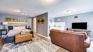 Laptop workspace, iron/ironing board, bed sheets