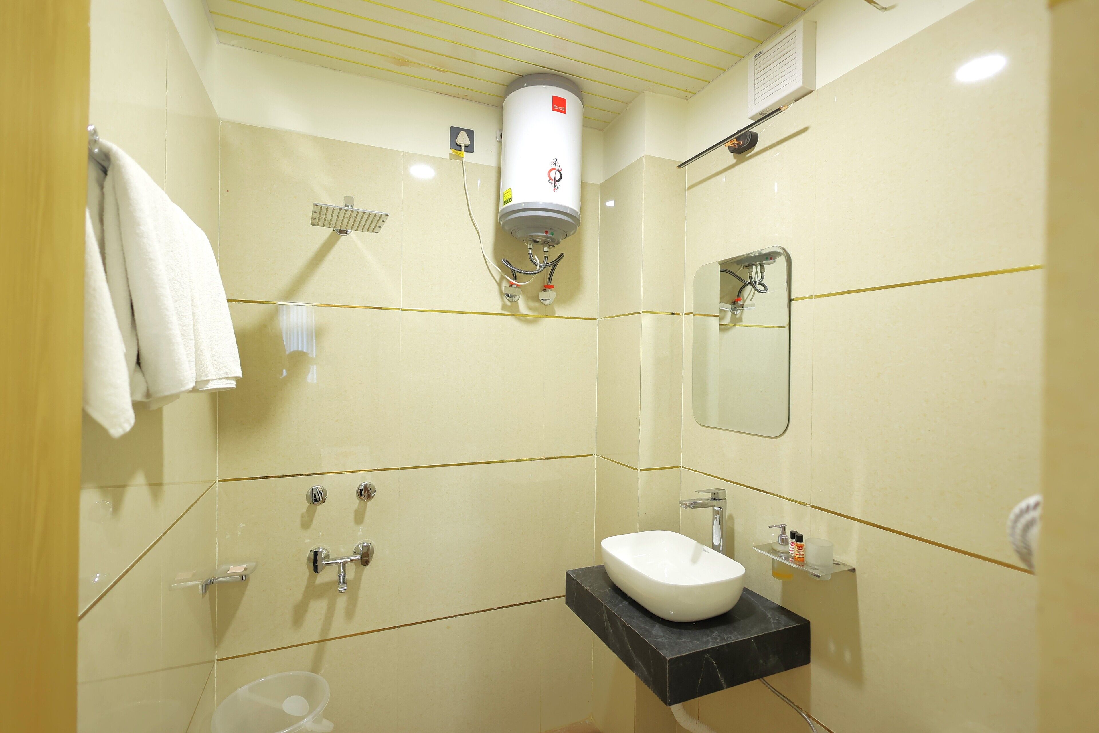A bathroom with a white sink, a mirror, a towel rack, and a towel hanging on it.