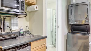 A compact kitchen with a microwave, stove, sink, and built-in oven. - Cozy Jonesboro Studio w/ Patio ~ 22 Mi to Atlanta! (Jonesboro)