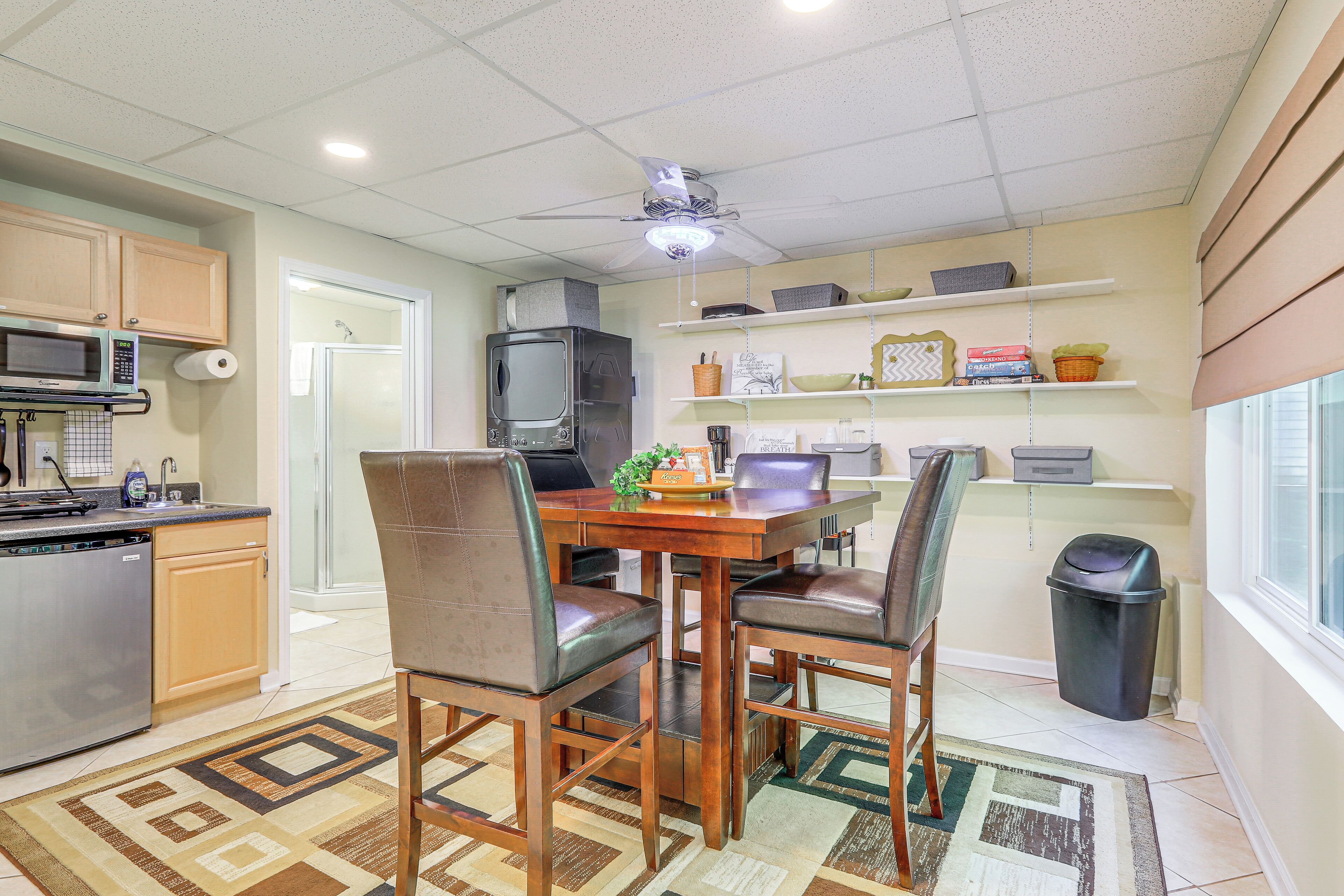A compact kitchen with a dining area, microwave, and a small television.