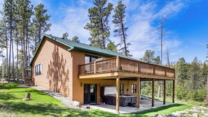 A two-story cabin with a covered deck and a hot tub. - Lead Home in the Mountains w/ Hot Tub + Views! (Lead)