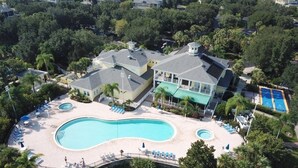 An aerial view of a residential area with a large swimming pool surrounded by lounge chairs and a small bridge. - 3 Bed 2 Bath Condo Bahama Bay Resort 3 Bedroom Condo by RedAwning (Davenport)