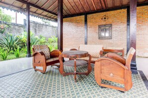Sit and relax in this serene outdoor seating area with a traditional bench and table.