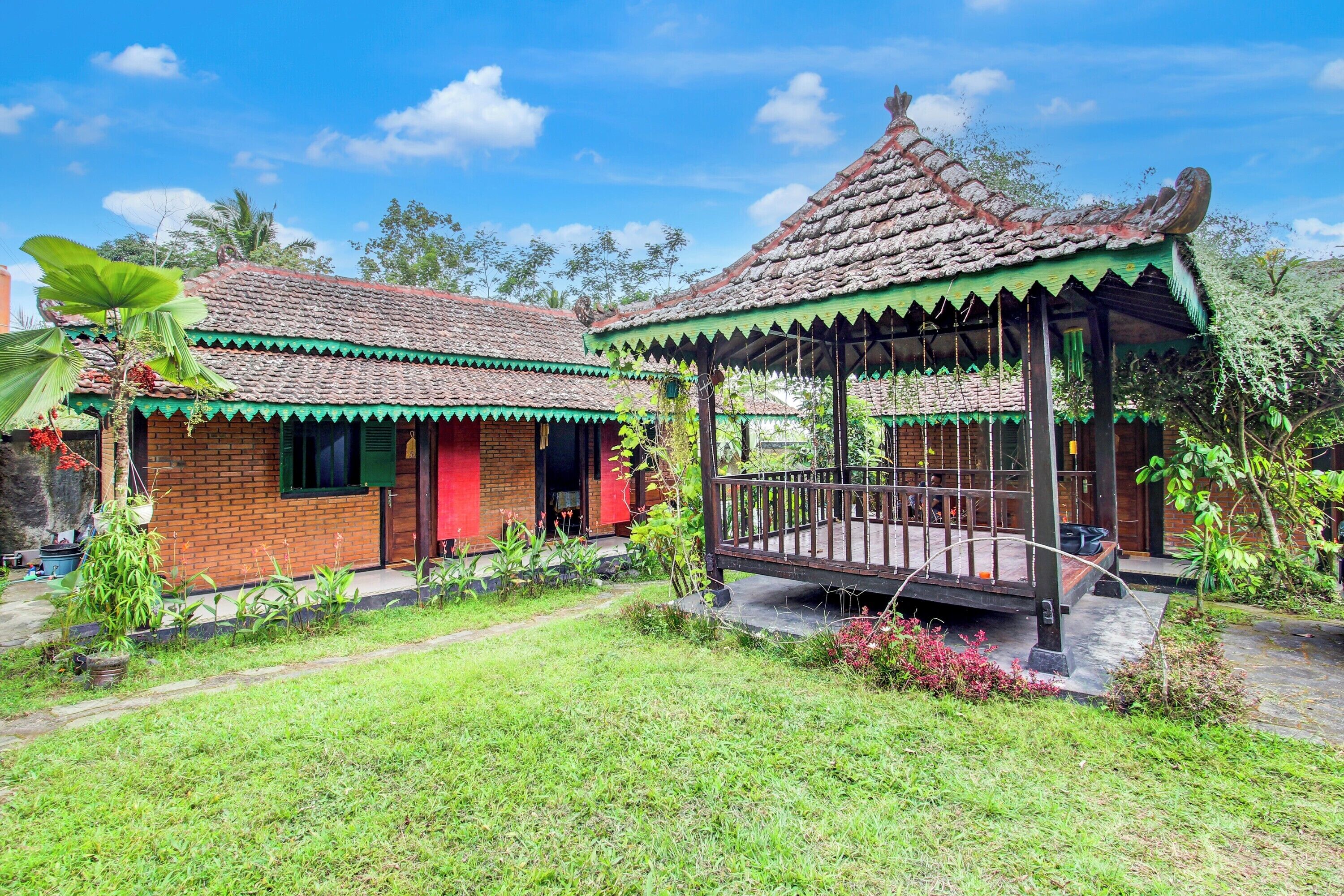 A traditional house with a tiled roof and a wooden gazebo.