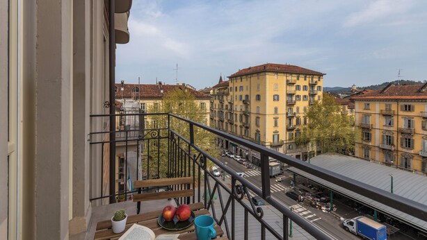 A balcony with a view of a cityscape, including buildings and a street. - Casa Ester in San Salvario by Wonderful Italy (Turin)