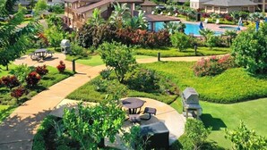 A residential area with houses, a swimming pool, and a patio with outdoor furniture.