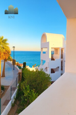 A modern white building with a balcony overlooking a coastal view. - Exclusive Penthouse | Privacy and Sea View in Vistamar – KNI Torrox (Torrox costa)