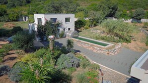 A modern house with a swimming pool, surrounded by lush greenery and a well-maintained garden. - 8 Bedroom Villa in tomino (tomino)