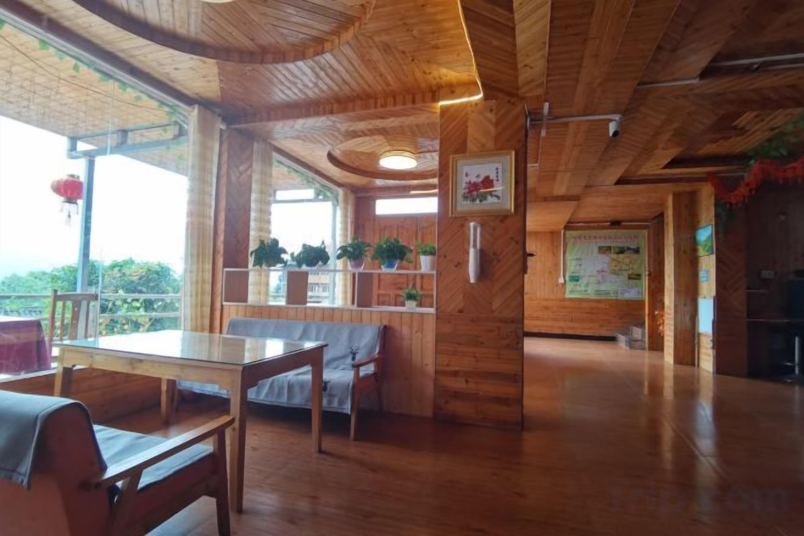Un interno in legno con zona pranzo, posti a sedere e vista dalla finestra.