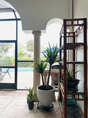 Enjoy a serene view of the outdoor pool from the comfort of this stylish room.