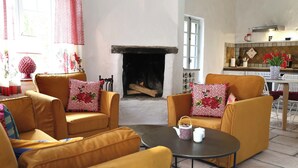A cozy living room with a fireplace, yellow sofas, and patterned cushions. - Minori - 2 Bedroom - Private Terrace - Amazing View (Villarzel-Cabardès)