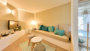 A cozy living room with a sofa, a coffee table, and a TV. - Heated indoor swimming pool - oyster beds (Le Tour-du-Parc)