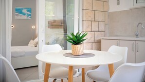 A modern kitchen with a white countertop, a sink, and a potted plant on the table. - Beachfront Villa near Zlatni rat (Bol)