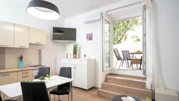 Family Apartment, 2 Bedrooms, Beachfront | Private kitchen | Mini-fridge, high chair, cookware/dishes/utensils
