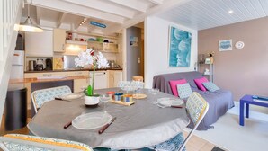 A well-lit, modern kitchen with wooden cabinets and a dining area set for a meal.