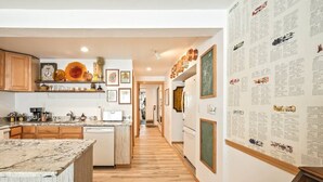 A modern kitchen with wooden cabinets, a marble countertop, and a wooden floor. - Quaint walkable to Downtown Cashmere (Cashmere)